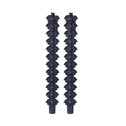 Pair of black taper candles molded with a stack of bat silhouettes, on white.