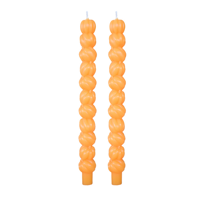 Pair of orange taper candles molded as stacked pumpkins, on white.