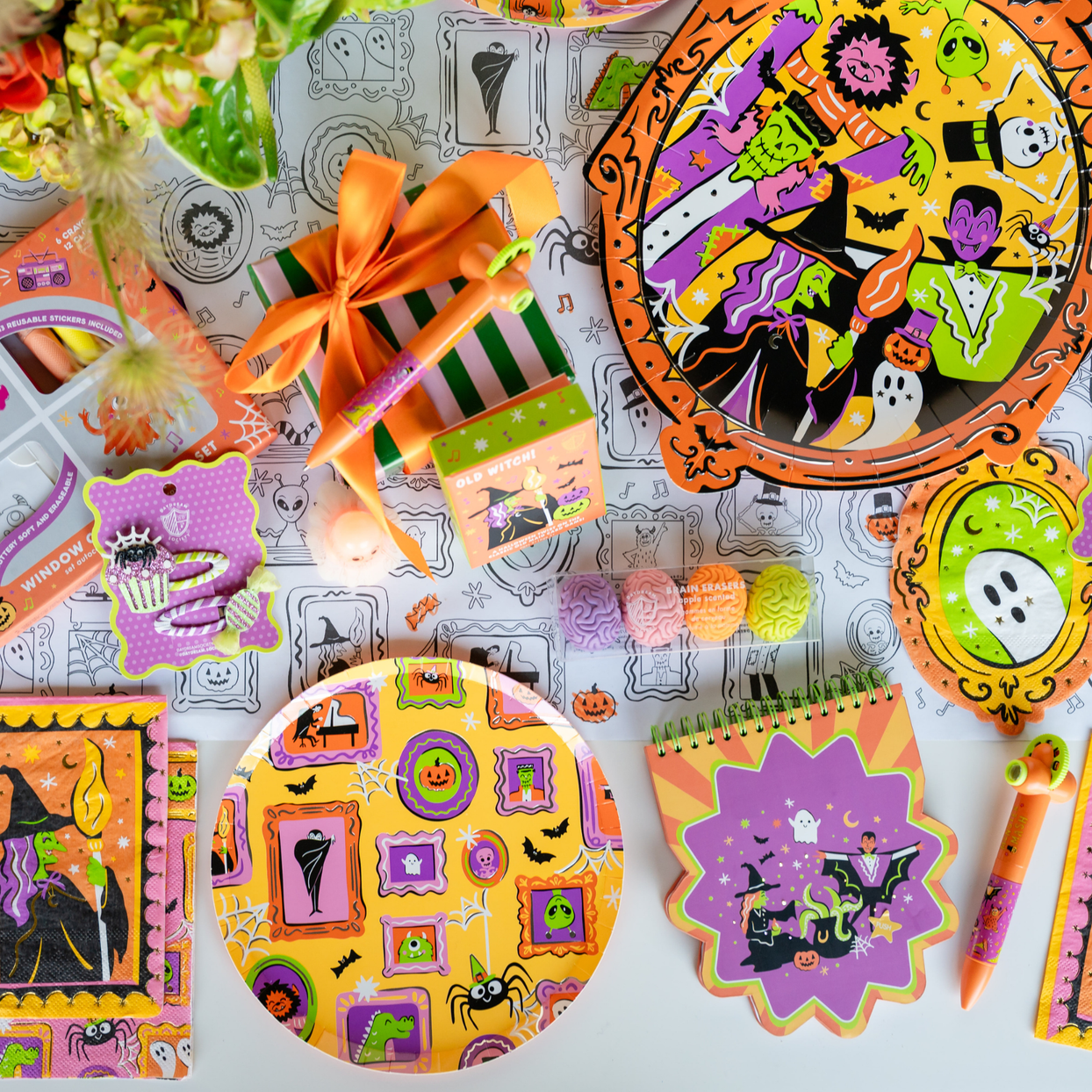 Monster Mash spread with framed-monster plates, crayon favors, notepads, and a ghost-frame napkin.